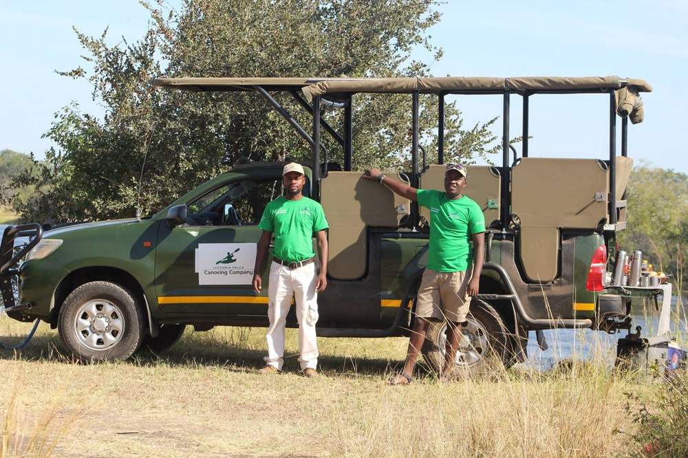 Two of our guides standing beside the company vehicle at the river